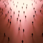 People walking towards a light