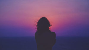 Silhouette of woman watching a sunset